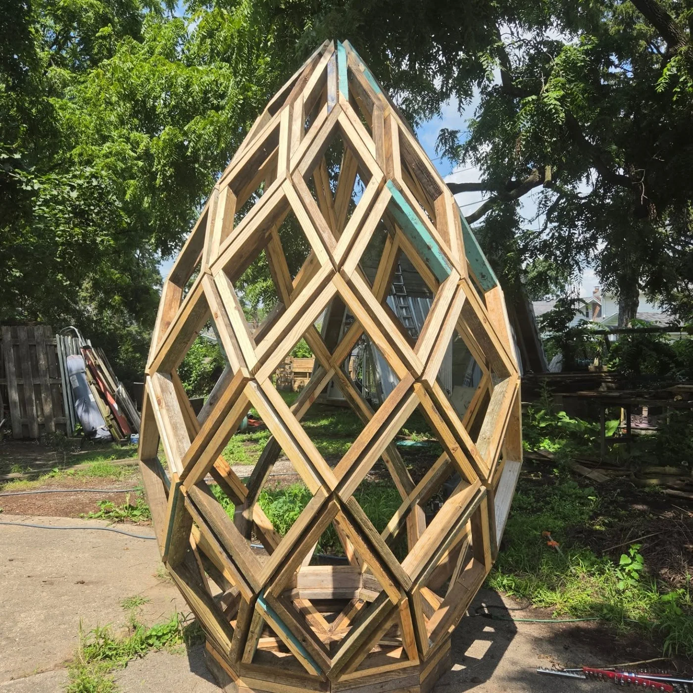 Neil Crum’s egg-shaped wooden sculpture, formed from an open lattice of interlocking geometric frames.